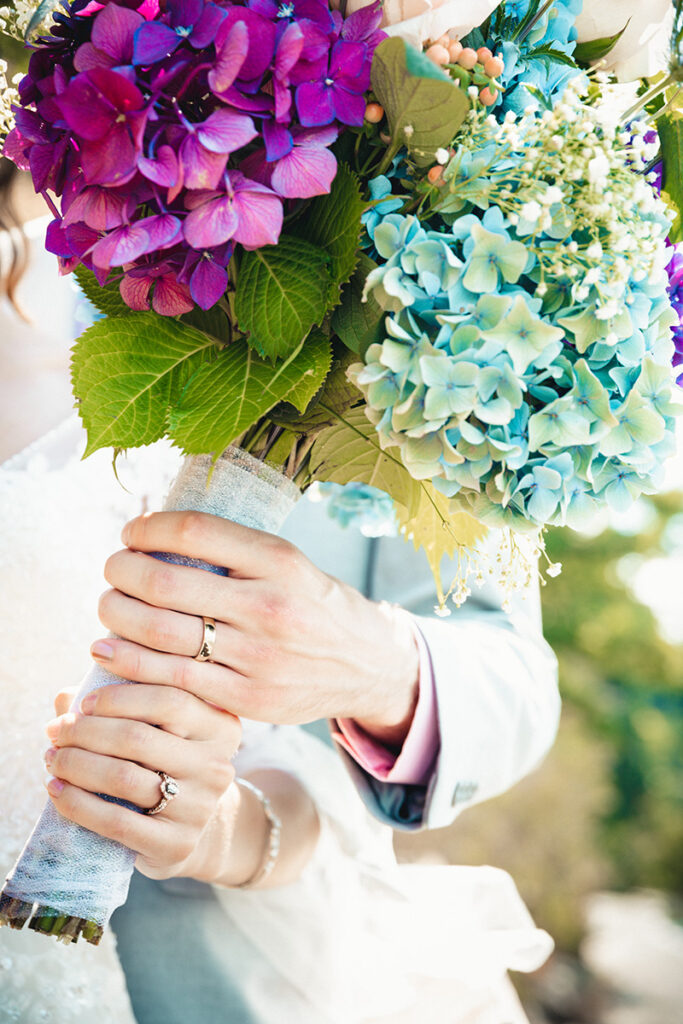 bride and groom holding wedding bouquet by Kiriell Visuals