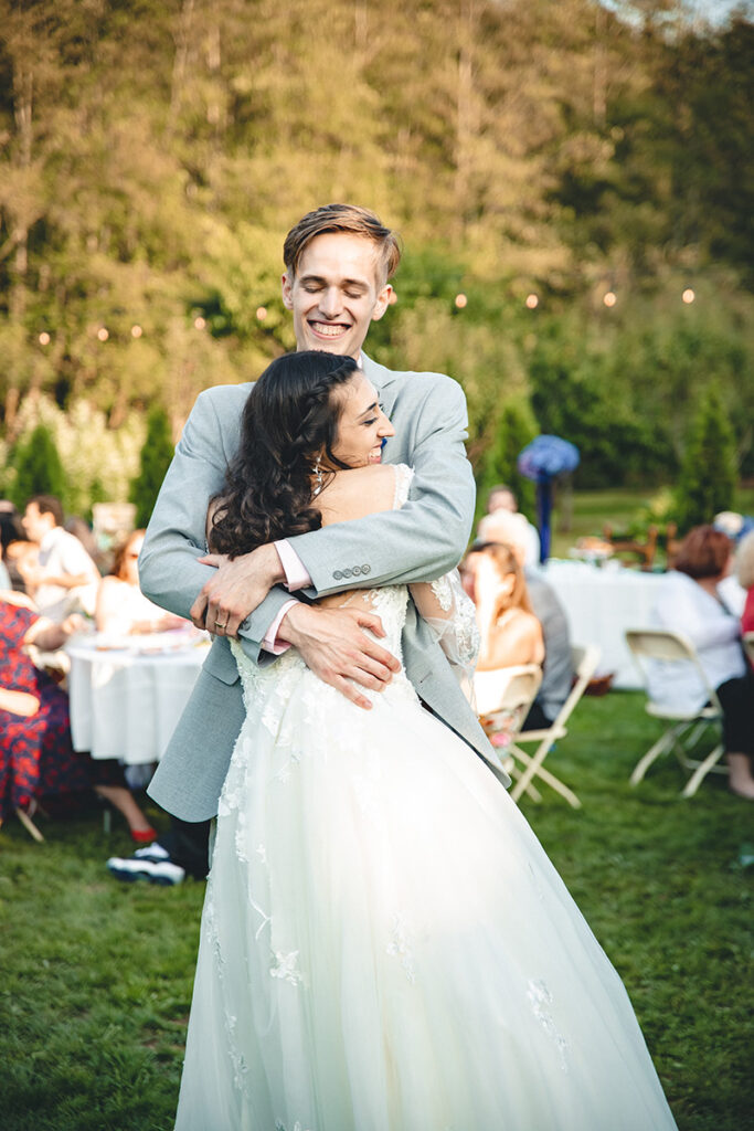 bride and groom hugging at outdoor wedding
